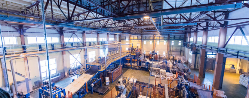 Factory workshop interior and machines on glass production background